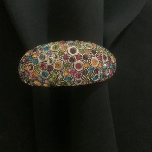 Multicolored gemstone bangle bracelet in silver with hinge opening.